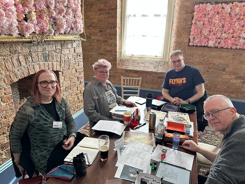 Four players around a gaming table at the Garrison playing Tales of the Old West.
